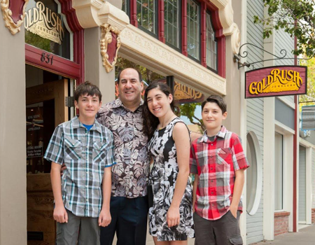 Rick Lewis and family in front of his jewelry store, Gold Rush Jewelers