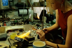 Blonde woman soldering jewelry